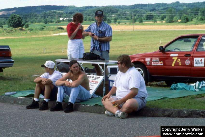 Jon Thompson and Norm Johnson chat on the curb