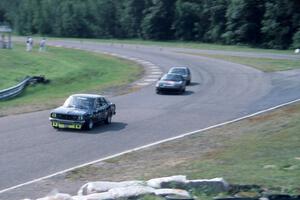 John Glowaski's ITB Dodge Colt, Stu Lenz' SSA Mazda RX-7 and an unidentied car head through turn 9