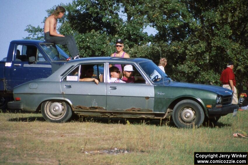 ASCC members hanging out in a ratted-out Peugeot 504