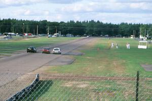 Bob Roth's ITA Chevy Citation X-11, Bill Fish's ITC Datsun 510 and Mark Utecht's ITB Dodge Omni go three-wide toward turn 10