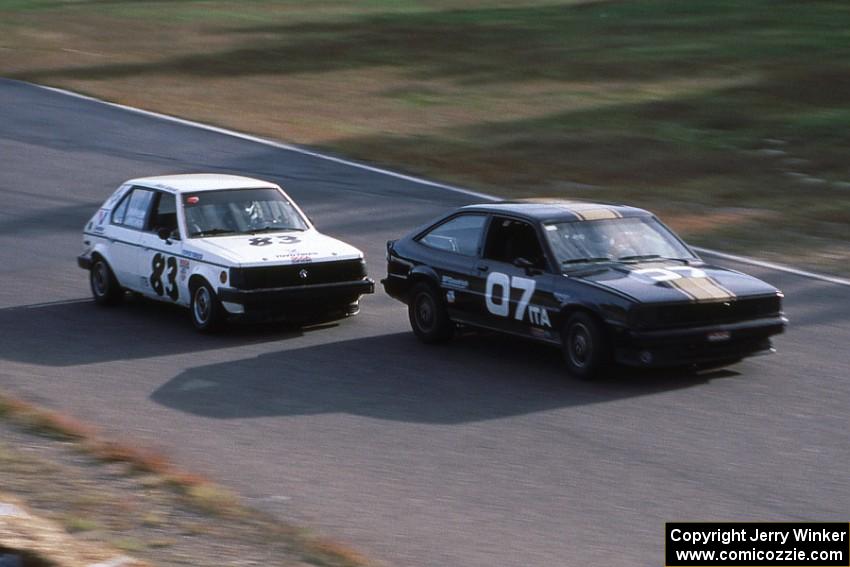 Bob Roth's ITA Chevy Citation X-11and Mark Utecht's ITB Dodge Omni head under the bridge