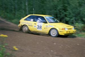 Steve Nowicki / Mark Greenisen blast past in their PGT Mazda 323GTX.