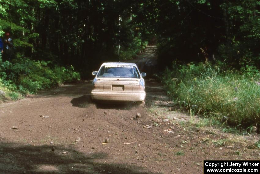 Tim O'Neil / Tom Burgess take a conservative approach out of the corner in their Mitsubishi Galant.