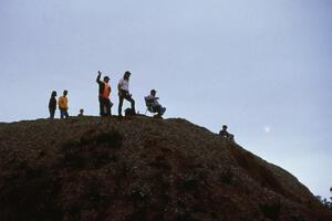 Rally marshall Mike Rappa waves from atop the dirtpile spectator point.