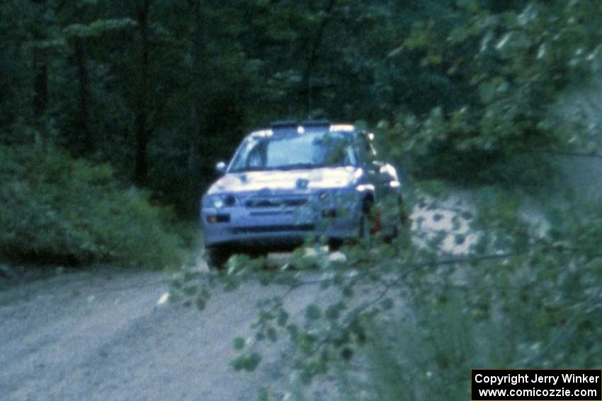 Carl Merrill / J. Jon Wickens Ford Escort Cosworth RS takes it easy at the Two Inlets yump.