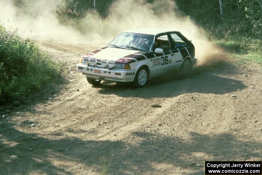 The Craig Sobczak / Kevin DeLoughary Mazda 323GTX at the 90-right on Indian Creek Forest Rd.