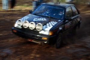 Steve Gingras / Bill Westrick muddy up their Mazda 323GTX.