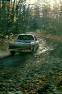 Roger Hull / John Elkin slide through a corner in their Mitsubishi Pickup.