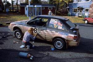 The Steve Gingras / Bill Westrick Mazda 323 GTX gets a rubdown from Diane Sargent.