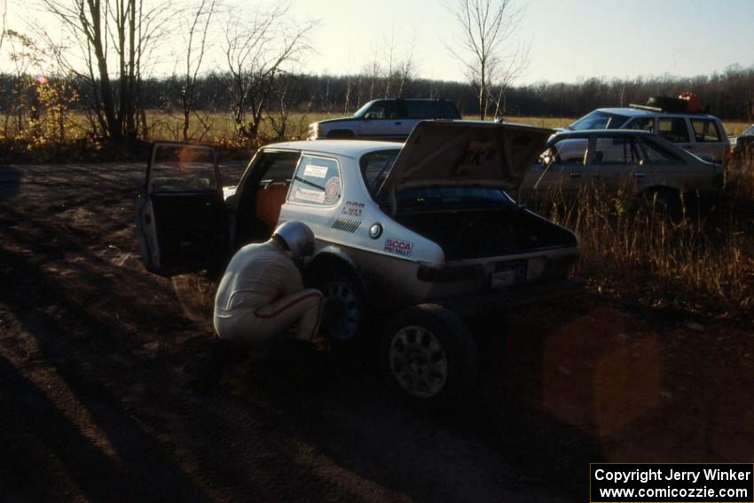 Tom Gillespie / Bill Smith DNF'ed in their SAAB 99 seen here changing a tire.