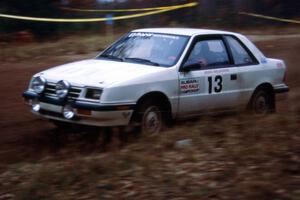 Henry Krolikowski / Cindy Krolikowski at speed through the spectator corner on SS1 in their Dodge Shadow.