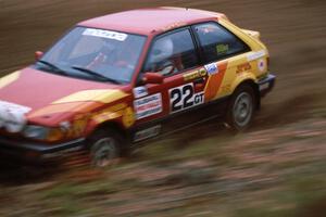 Stuart Sarasin / Craig Sobczak at speed through the spectator location on SS1 in their Mazda 323GTX.