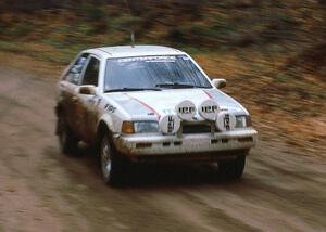 Henry Joy IV / Jimmy Brandt at speed on the first stage of day two in their Mazda 323GTX.