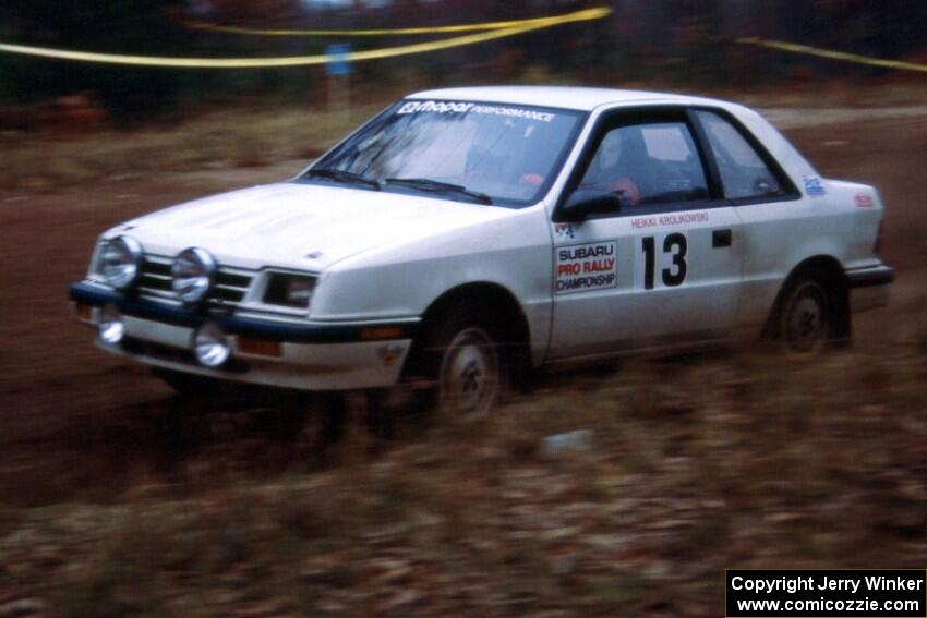 Henry Krolikowski / Cindy Krolikowski at speed through the spectator corner on SS1 in their Dodge Shadow.