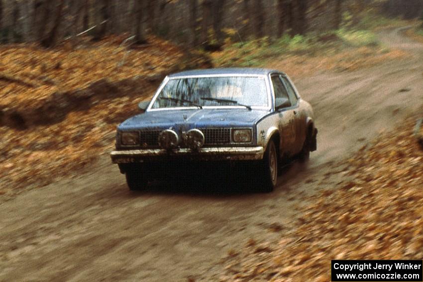 Ed Maklenburg / Barbara Steencken at speed in their Oldsmobile Omega on the first stage of day two.