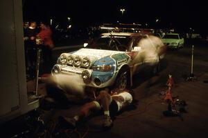 Mechanics are a blur on the Peter Moodie / Mike Fennell Mazda 323GTR at service on day one.