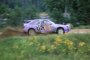 The Carl Merrill / John Bellefleur Ford Escort Cosworth blasts down the county road away from the spectator corner.