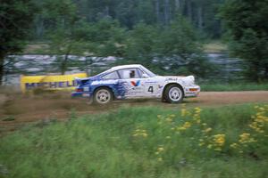 The Jeff Zwart / Martin Headland Porsche Carrera 4 accelerates onto the county road.