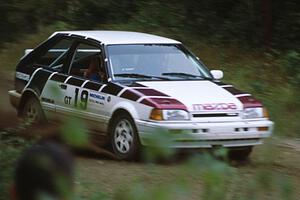 Craig Sobczak / Kevin DeLoughary carry too much speed in their Mazda 323GTX and head into the ditch.