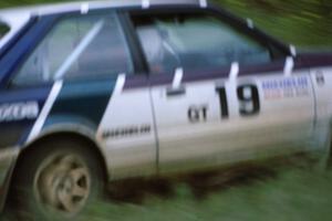 Craig Sobczak / Kevin DeLoughary keep on the gas while in the ditch at the spectator location in their Mazda 323GTX .