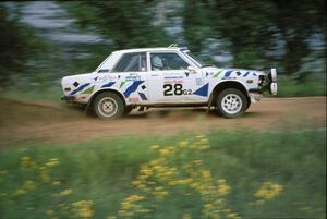 The Mike Whitman / Kevin Linville Datsun 510 powers away from the spectator corner at the county road.