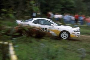 Jason Priestley / Kevin Caffrey kick up gravel at the outside of a blind sweeper in their Toyota Celica All-Trac.