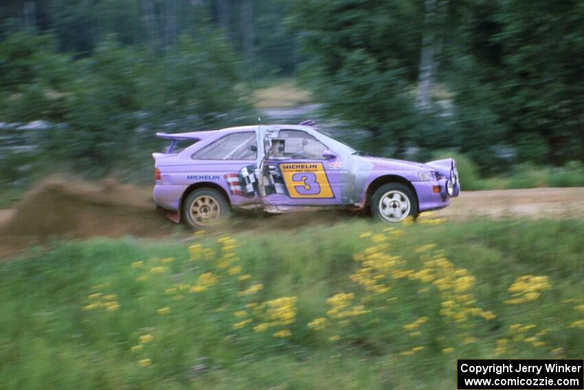 The Carl Merrill / John Bellefleur Ford Escort Cosworth blasts down the county road away from the spectator corner.