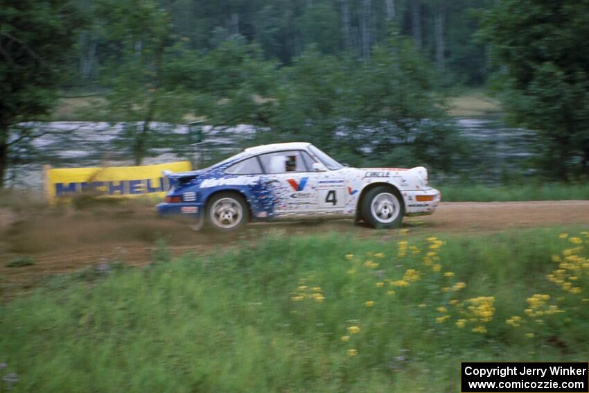 The Jeff Zwart / Martin Headland Porsche Carrera 4 accelerates onto the county road.