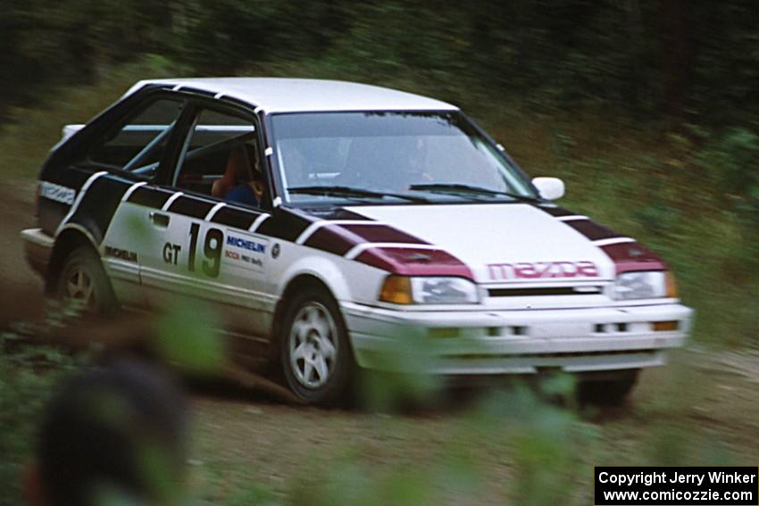 Craig Sobczak / Kevin DeLoughary carry too much speed in their Mazda 323GTX and head into the ditch.
