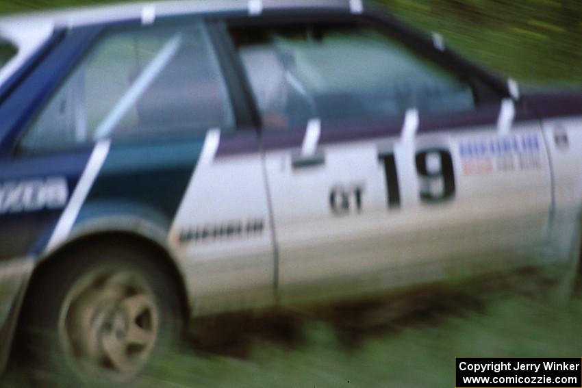 Craig Sobczak / Kevin DeLoughary keep on the gas while in the ditch at the spectator location in their Mazda 323GTX .