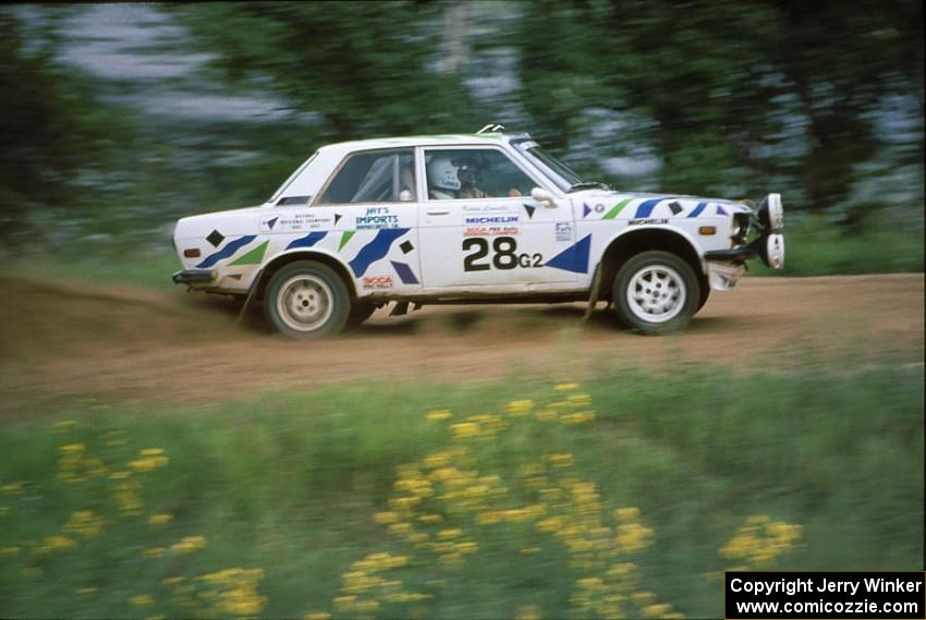 The Mike Whitman / Kevin Linville Datsun 510 powers away from the spectator corner at the county road.