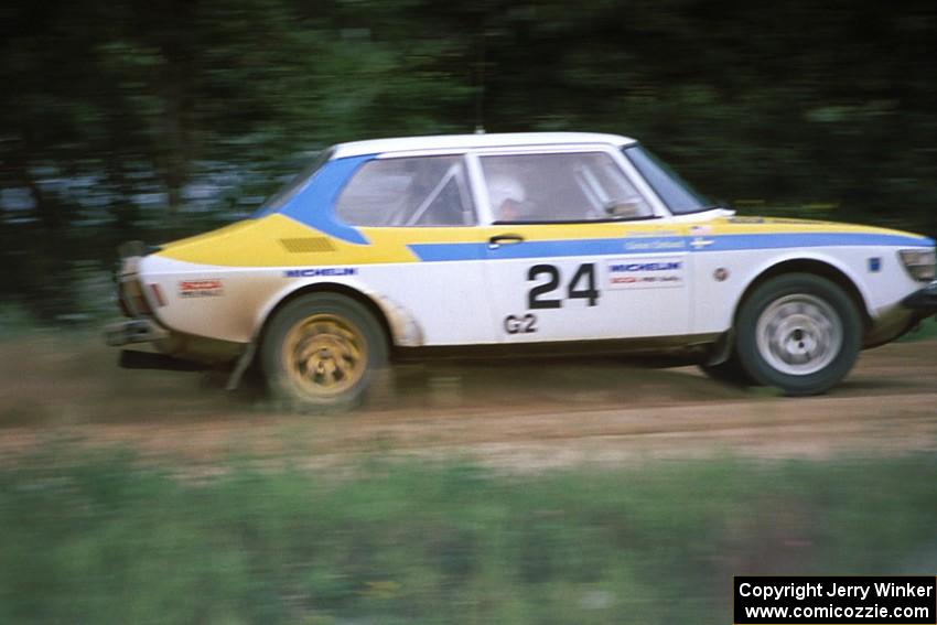 The Goran Ostlund / Steve Baker SAAB 99 blasts down the straight after the spectator corner at the county road.