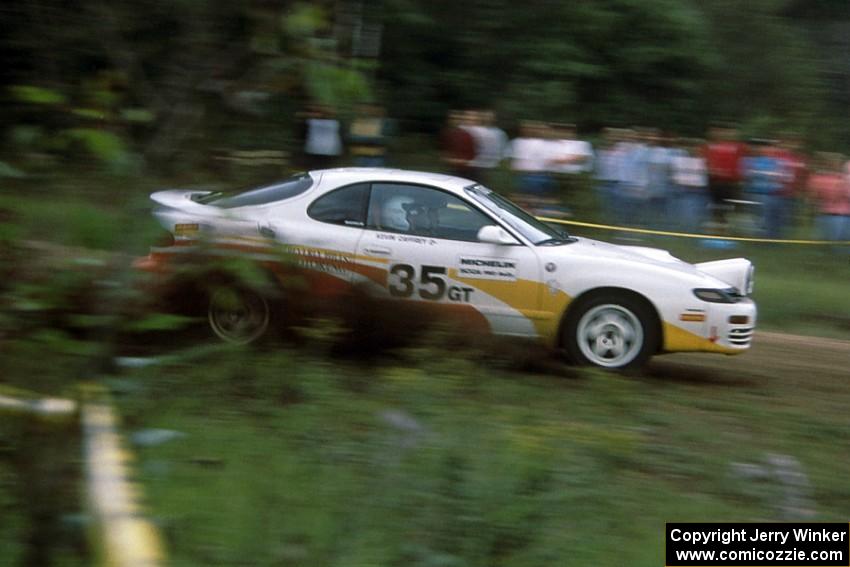 Jason Priestley / Kevin Caffrey kick up gravel at the outside of a blind sweeper in their Toyota Celica All-Trac.