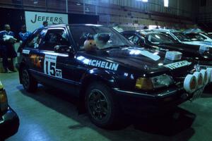 A festive Tom Ottey / Pam McGarvey in their Mazda 323GTX at parc expose (1).