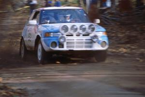 Peter Moodie / Michael Fennell in their Mazda 323GTR blast into the final corners of SS1.