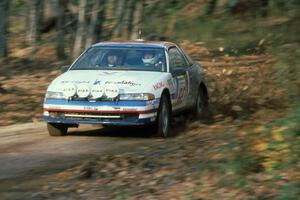 Dave Turner / Bill Gutzman in their Mitsubishi Eclipse kick up leaves near the finish of SS1.