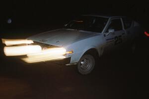 Chris Czyzio / Eric Carlson negotiate the spectator corner on Passmore in their Plymouth Arrow at night.