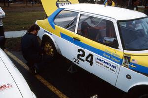 Sean Tennis works on the Goran Ostlund / Steve Baker SAAB 99 at Saturday morning parc expose.