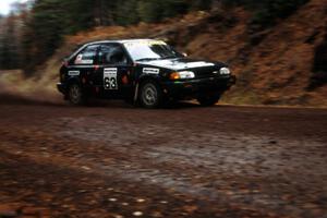 Rees Harris / Constantine Manotopoulos in their Mazda 323GTX blast uphill at the start of Delaware.