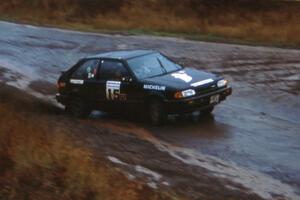 Tom Ottey / Pam McGarvey in their Mazda 323GTX slide wide at the Delaware delta.