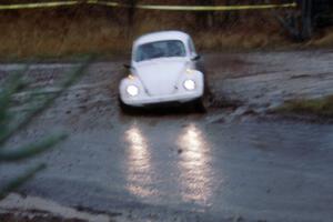 Headlights glimmer off the wet pavement from the Rene Villemure / Mike Villemure VW Beetle.