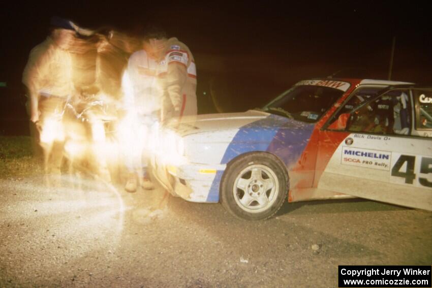 Rick Davis / Ben Greisler BMW M3 at L'Anse service adjusting the lights.