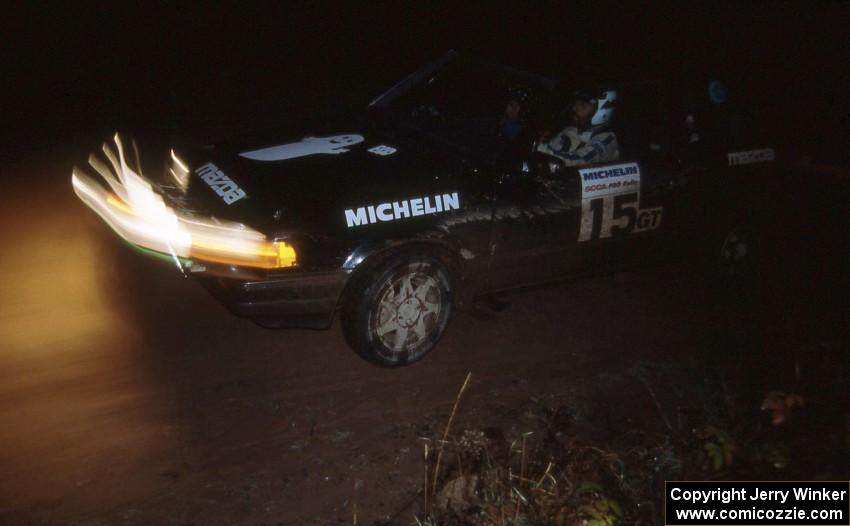 Tom Ottey / Pam McGarvey in their Mazda 323GTX hit the night stages.