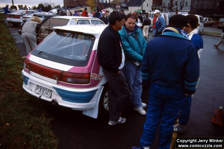 Rod Millen (in teal jacket) was on hand to help the Peter Moodie / Michael Fennell Mazda 323GTR team.