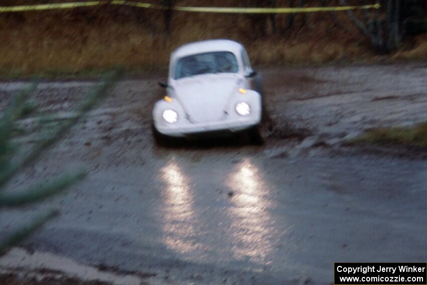 Headlights glimmer off the wet pavement from the Rene Villemure / Mike Villemure VW Beetle.