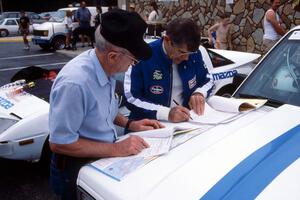 Ken Stewart goes over notes with a crew member(?) on the hood of the Chevy S-10 he and Doc Shrader shared.