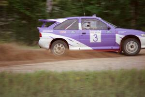 Carl Merrill / John Bellefleur accelerate from the county road spectator point in their Ford Escort Cosworth.