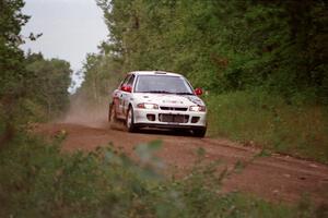 Henry Joy IV / Chris Griffin in their Mitsubishi Lancer Evo II come into the spectator location at the county road.