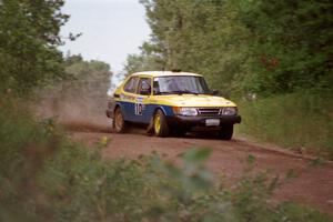 Sam Bryan / Rob Walden drift their Saab 900 through a sweeper over a rise on Indian Creek Trail Rd.