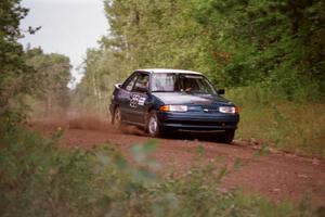 The Tad Ohtake / Bob Martin Ford Escort GT at speed down Indian Creek Trail Rd. on day two.